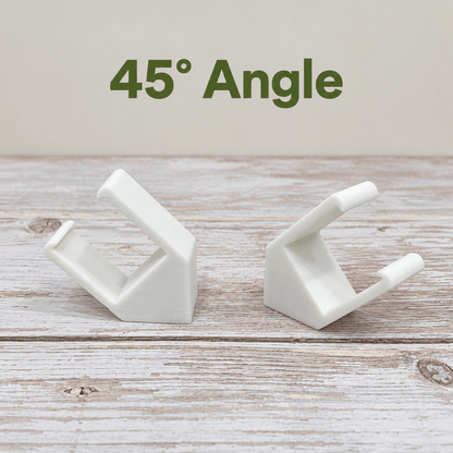 Two white PETG magnetic mounts for Barrina T5 grow lights on a pale wood surface, labeled 45° Angle.