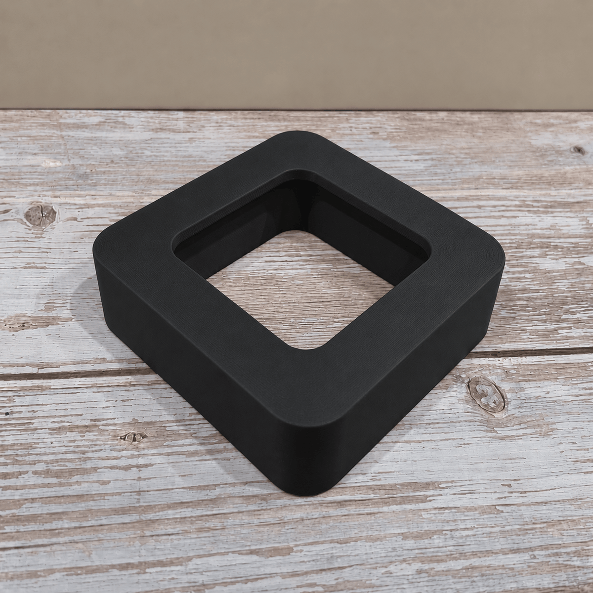 Black Govee H5179 magnetic hygrometer mount shown without the sensor on a light wooden tabletop.