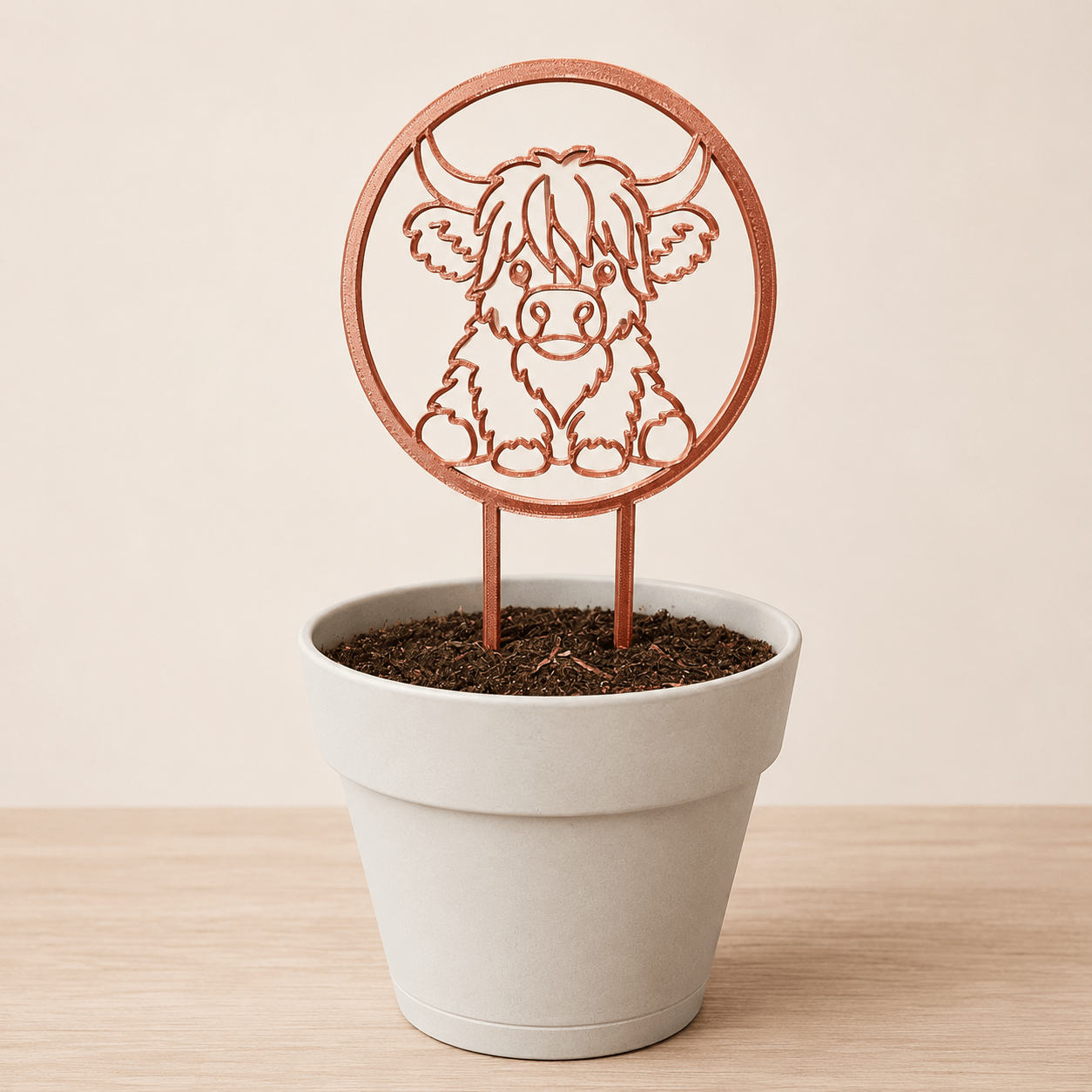 Copper silk Highland cow plant trellis displayed in a decorative pot