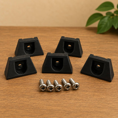 Black corner protectors with screws on a wooden surface