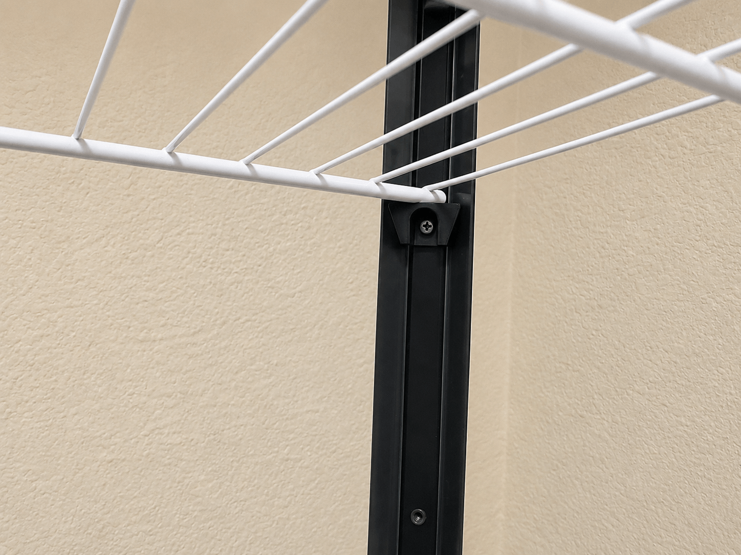 Corner mounting bracket installed for a DIY wire shelf inside an IKEA Milsbo cabinet.
