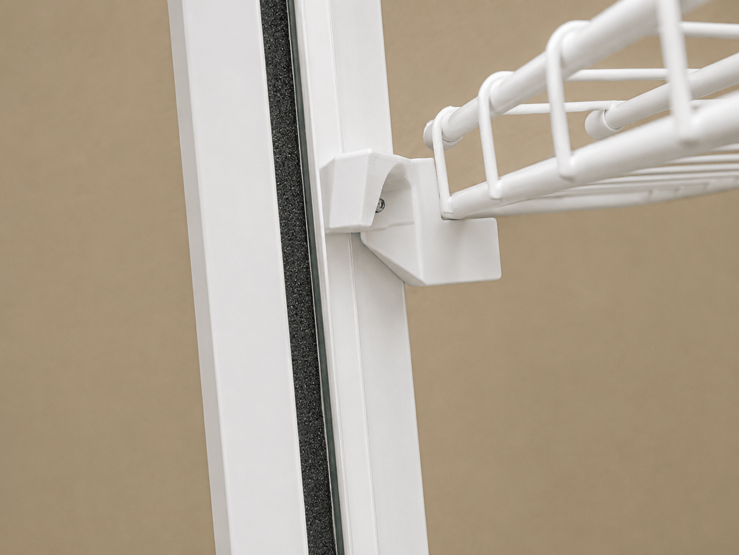White front corner mounting bracket supporting a wire shelf inside an IKEA Milsbo Tall cabinet.