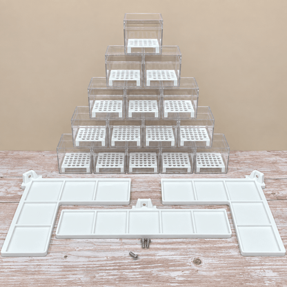 A set of clear plastic organizer drawers with white inserts, arranged in a pyramid stack on a rustic wooden table against a beige background, with white mounting brackets and small screws displayed in front.