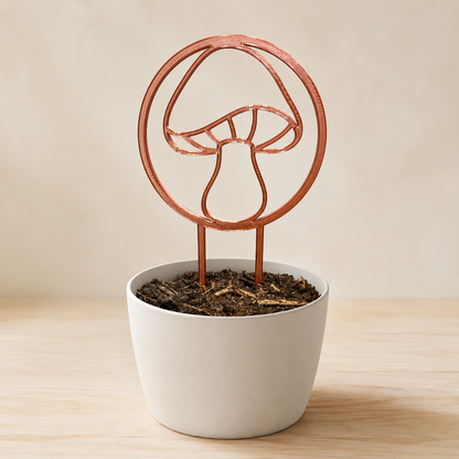 Decorative mushroom plant trellis displayed in an indoor flowerpot