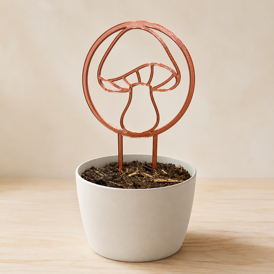 Decorative mushroom plant trellis displayed in an indoor flowerpot