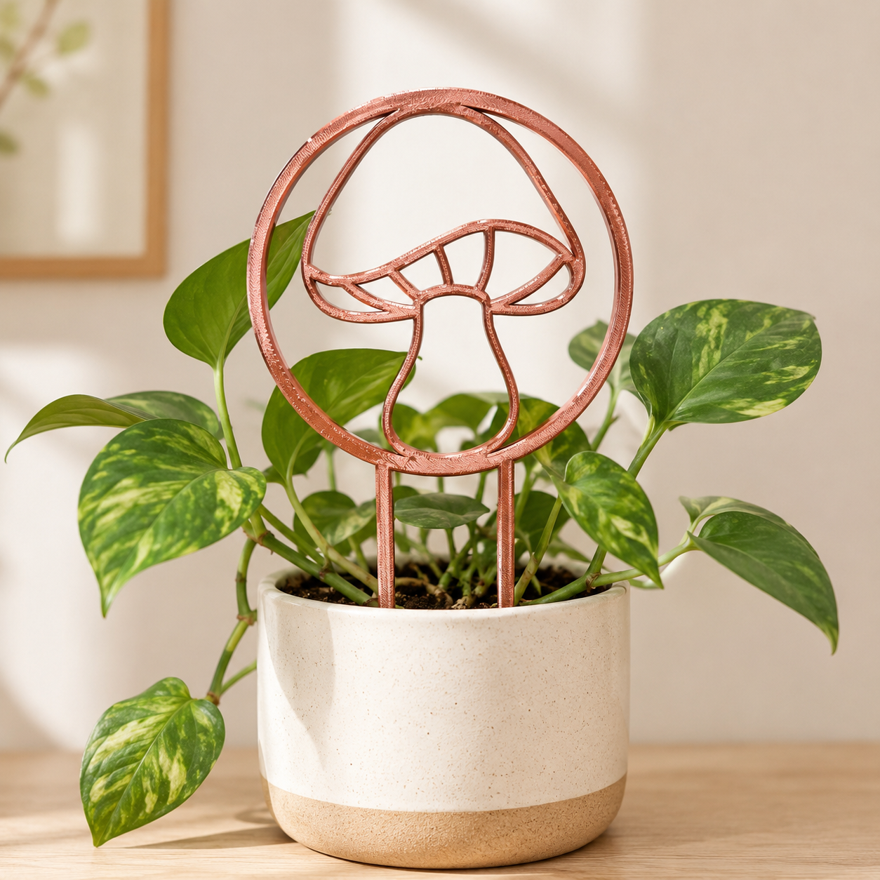 Copper silk mushroom trellis supporting climbing vines in a ceramic planter
