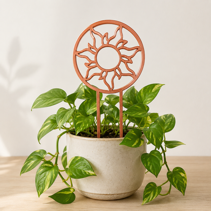 Copper silk sun trellis supporting climbing vines in a ceramic planter