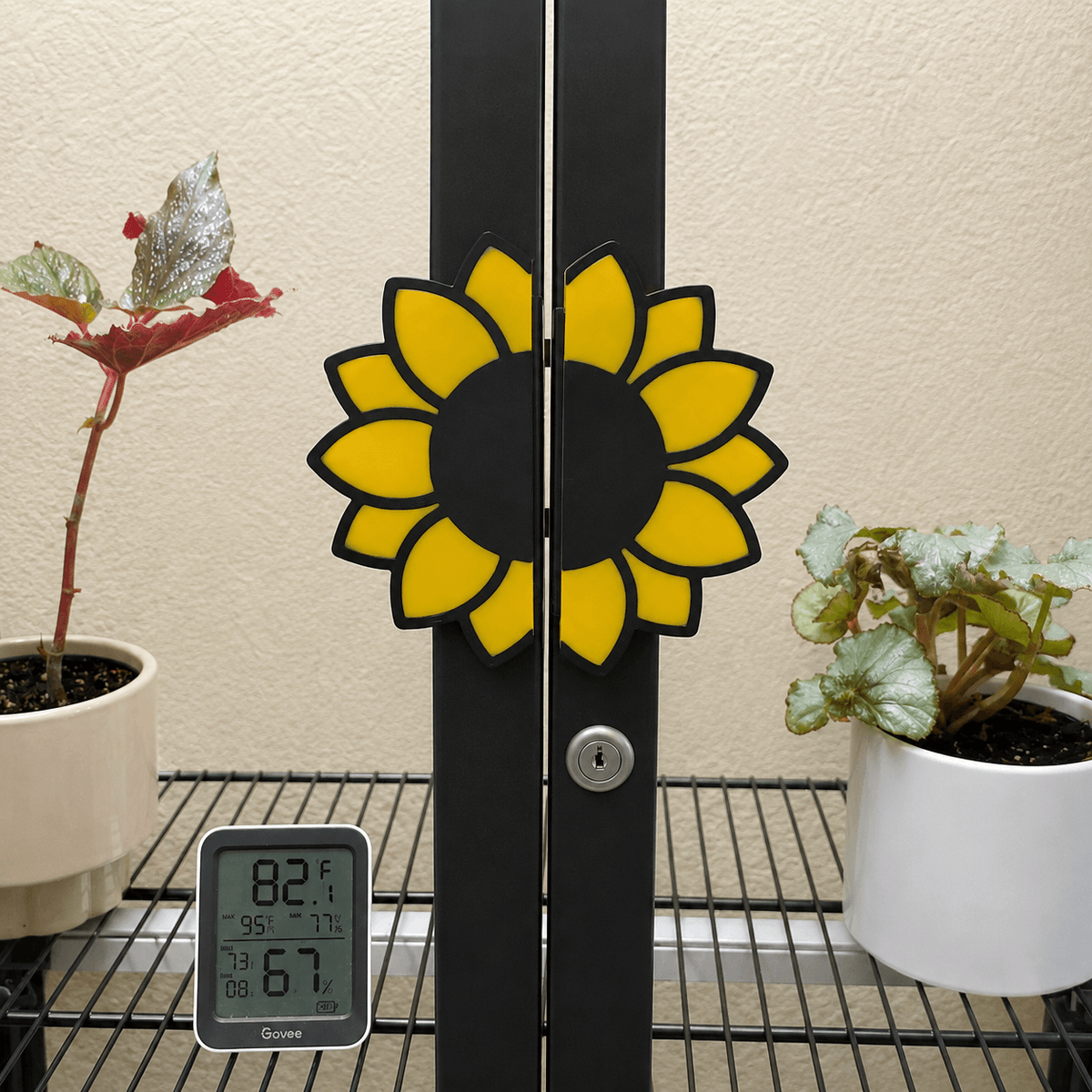Close-up of yellow and black sunflower handle covers installed on IKEA Milsbo Tall cabinet doors