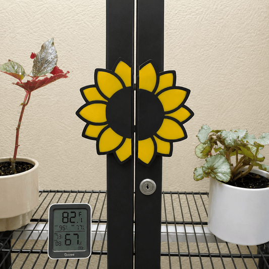 Close-up of yellow and black sunflower handle covers installed on IKEA Milsbo Tall cabinet doors