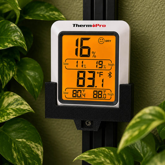 Thermopro digital thermometer with humidity gauge in front of green leaves