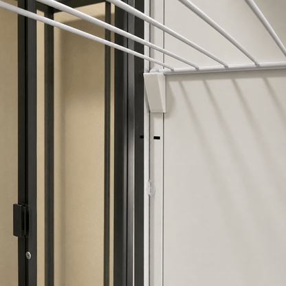 Close-up of a white hanging clothesline mounted on a light-colored wall next to a dark-framed door.
