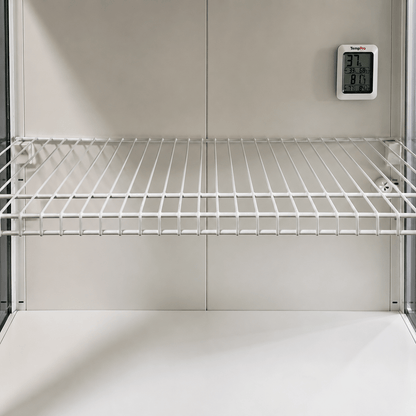 White wire storage shelf inside a refrigerator or freezer compartment, with a digital temperature display mounted on the back wall.