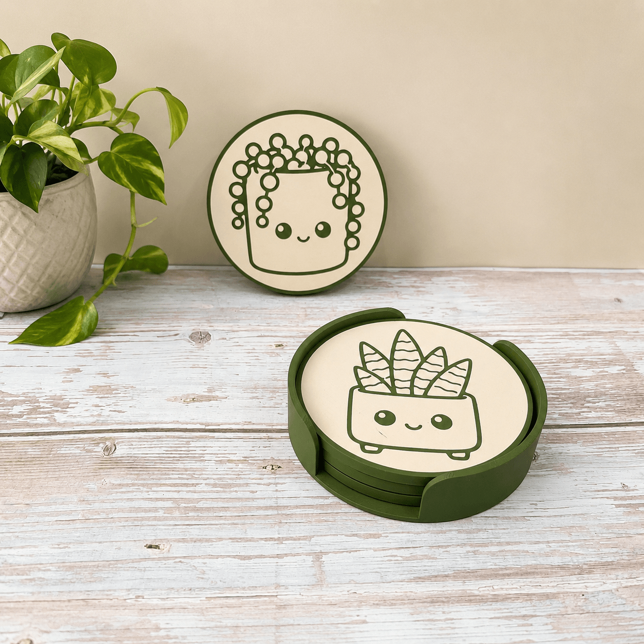 Whimlings plant coaster set displayed with a houseplant on a wooden table